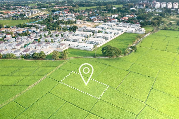 white houses next to rice fields with location symbol -best places to invest in real estate