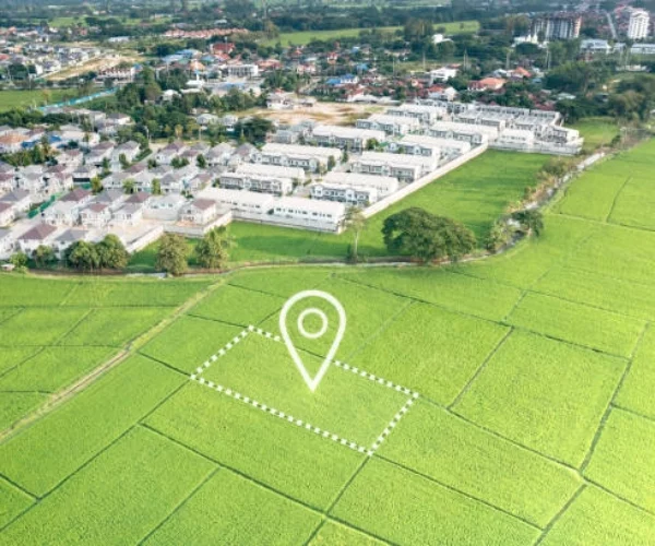 white houses next to rice fields with location symbol -best places to invest in real estate